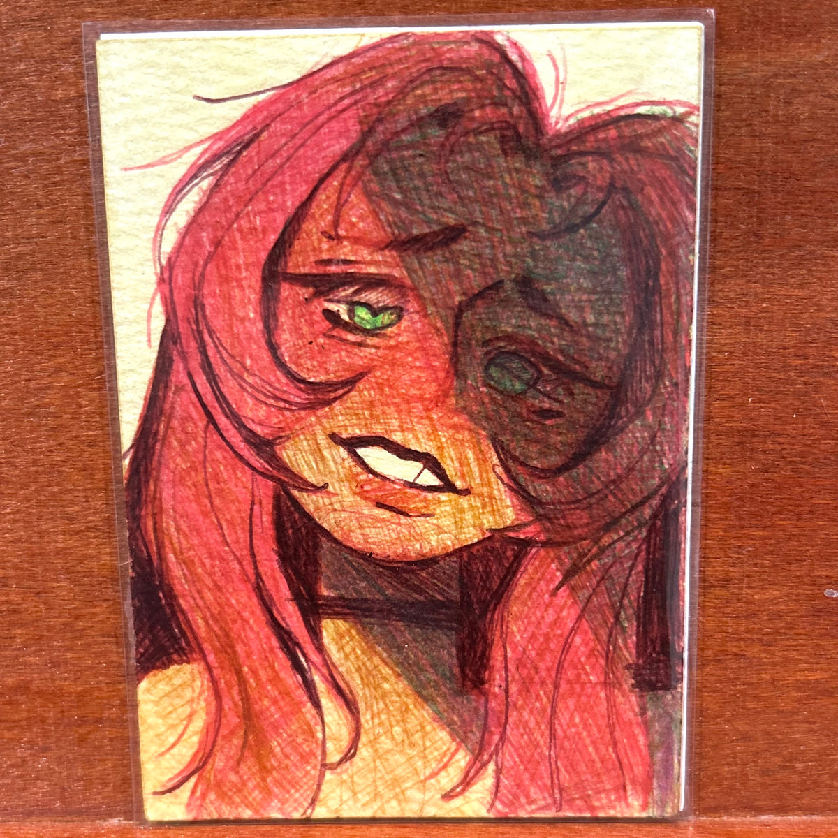 Full view of the original mixed media illustration titled Love Me Back featuring a stylized female portrait with long red hair and striking green eyes by Canvas of Sug